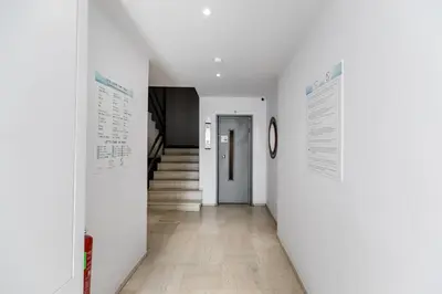 a hallway with white walls and a hallway with a staircase at Orion - Stunning Studio in Athens in Athens