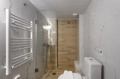 a white bathroom with a shower and a toilet at Orion - Stunning Studio in Athens in Athens