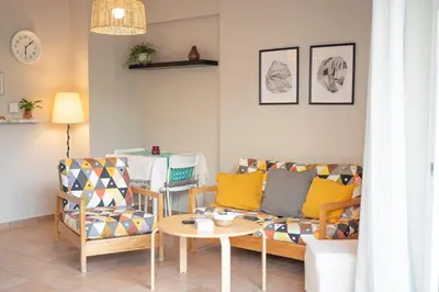 a living room with a couch and a table at VK Athens Center in Athens