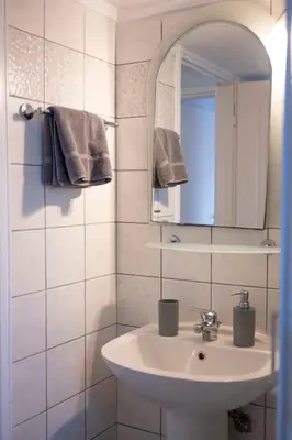 a white bathroom with a sink and a mirror at VK Athens Center in Athens