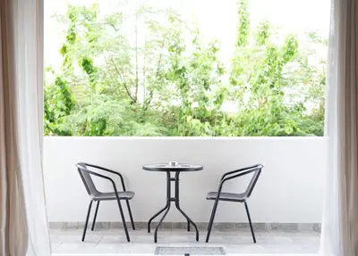 a table and two chairs in front of a window at VK Athens Center in Athens