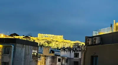 a group of buildings with a mountain in the background at Acropolis GrandView in Athens
