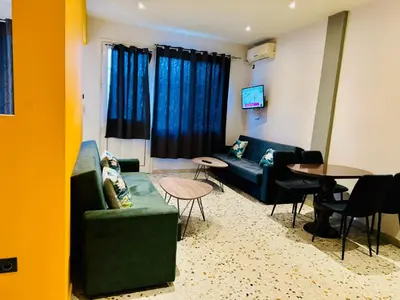 a living room with a couch and a table at Acropolis GrandView in Athens