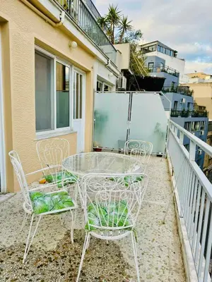 a glass table and chairs on a balcony at Acropolis GrandView in Athens