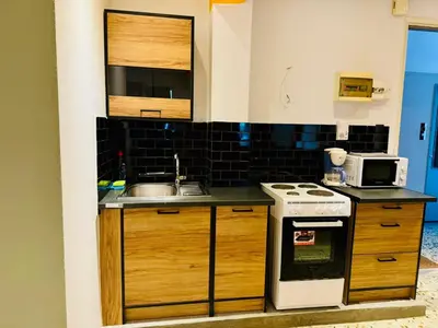 a kitchen with a sink and a stove at Acropolis GrandView in Athens