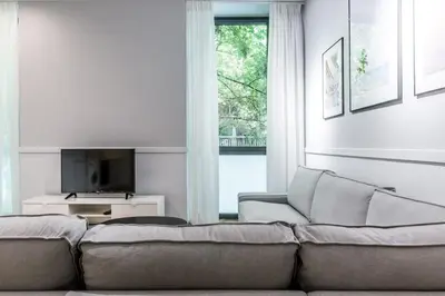 a living room with a couch and a television at Fully Renovated 2bdrm Apartment in Kolonaki area in Athens