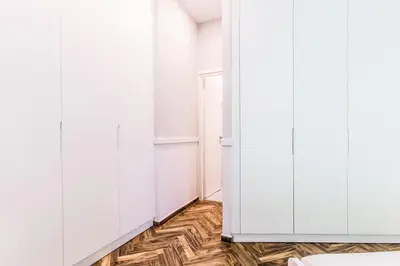 a room with white cabinets and a wooden floor at Fully Renovated 2bdrm Apartment in Kolonaki area in Athens