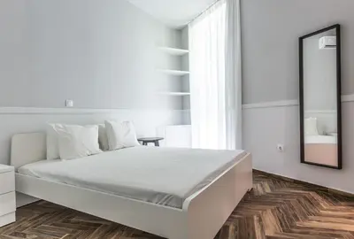 a white bedroom with a large bed and a mirror at Fully Renovated 2bdrm Apartment in Kolonaki area in Athens