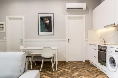 a kitchen and living room with a table and chairs at Fully Renovated 2bdrm Apartment in Kolonaki area in Athens