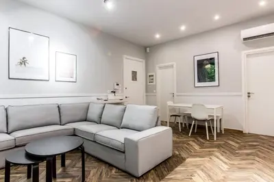 a living room with a couch and a table at Fully Renovated 2bdrm Apartment in Kolonaki area in Athens