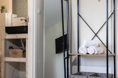 a bathroom with towels on a shelf at Nobia 8 in Athens