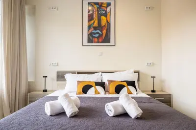 a bedroom with a bed with white towels on it at Nobia 8 in Athens