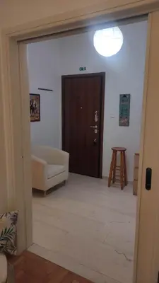 a living room with a couch and a door at Whole Apartment 52 square meters in the neigboor of Pagrati in Athens in Athens