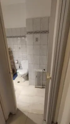 a bathroom with a toilet and a sink at Whole Apartment 52 square meters in the neigboor of Pagrati in Athens in Athens