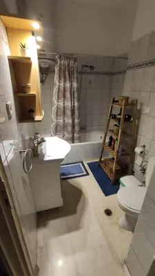 a bathroom with a sink and a tub and a toilet at Whole Apartment 52 square meters in the neigboor of Pagrati in Athens in Athens