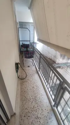 an empty room with a view of a room with a wall with at Whole Apartment 52 square meters in the neigboor of Pagrati in Athens in Athens