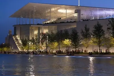 a large building with people standing in front of the water at Whole Apartment 52 square meters in the neigboor of Pagrati in Athens in Athens