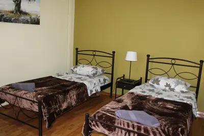 a room with two beds and a lamp in it at Petaluda House 1 in Athens