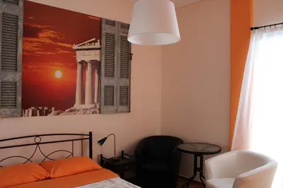 a bedroom with a bed and a picture on the wall at Petaluda House 1 in Athens