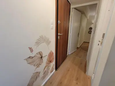 a hallway with a butterfly mural on a wall at Sunny Garden Apartment kolonaki in Athens