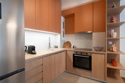 a kitchen with wooden cabinets and a sink at LIV - Trendy Athenian Apartment in Pagrati in Athens