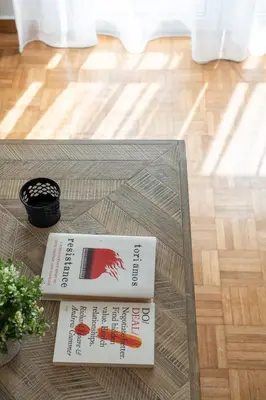 two books sitting on top of a glass table at LIV - Trendy Athenian Apartment in Pagrati in Athens