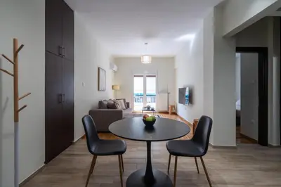 a living room with a table and chairs at LIV - Relaxing Pagrati Retreat in Athens in Athens