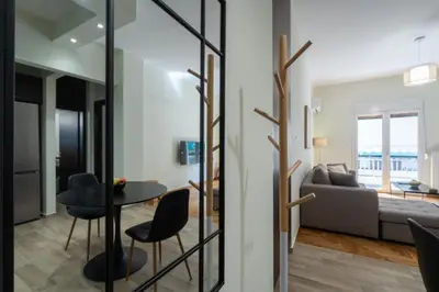 a living room with a table and chairs and a couch at LIV - Relaxing Pagrati Retreat in Athens in Athens