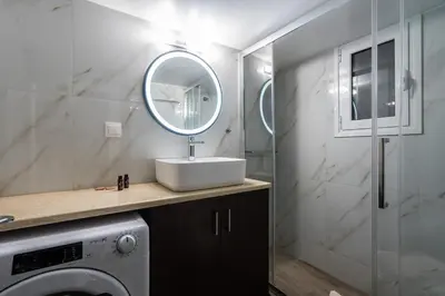 a bathroom with a sink and a mirror at LIV - Relaxing Pagrati Retreat in Athens in Athens