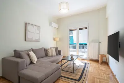 a living room with a couch and a tv at LIV - Relaxing Pagrati Retreat in Athens in Athens