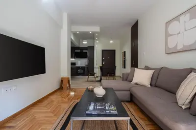 a living room with a couch and a tv at LIV - Relaxing Pagrati Retreat in Athens in Athens