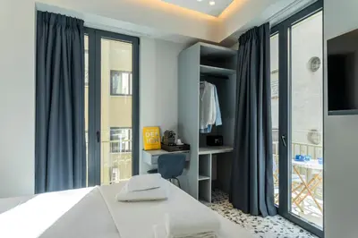 a bedroom with a bed and a large window at Athens Retro in Athens