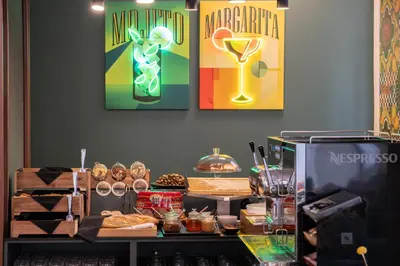 a counter with some food and posters on the wall at Athens Retro in Athens