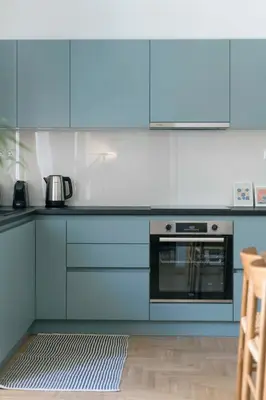 a kitchen with blue cabinets and an oven at Chic & Spacious 3BR Apartment at National Museum by UPSTREET in Athens