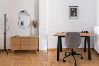an office with a desk and a chair and a mirror at Chic & Spacious 3BR Apartment at National Museum by UPSTREET in Athens
