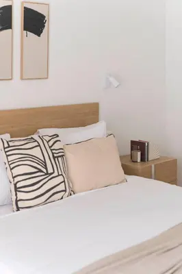 a bed with black and white pillows in a bedroom at Chic & Spacious 3BR Apartment at National Museum by UPSTREET in Athens