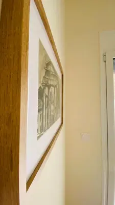 a picture hanging on a wall in a room at Ilisia mini suite in Athens