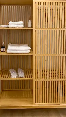 a wooden shelf with towels and towels in a room at Ilisia mini suite in Athens