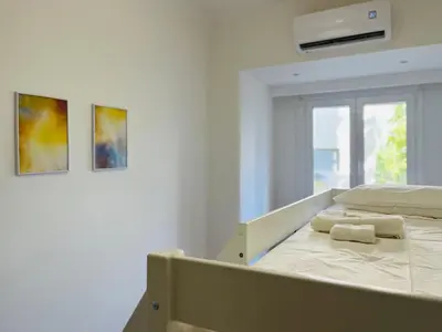 a bedroom with a bed with two towels on it at Acropolis Luxe Retreat in Athens