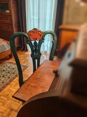 a wooden table and chair in a room at Retro private room in common apartment in Athens