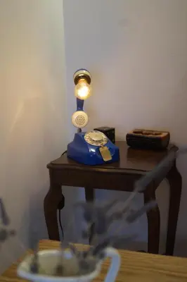 a blue lamp sitting on top of a table at Retro private room in common apartment in Athens