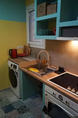a kitchen with a sink and a washing machine at Retro private room in common apartment in Athens