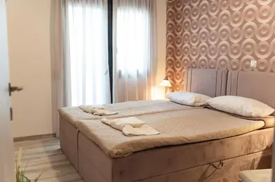 a bedroom with a bed with towels on it at Downtown Penthouse With Gym And Acropolis View in Athens