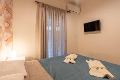 a bedroom with a bed with two towels on it at Downtown Penthouse With Gym And Acropolis View in Athens