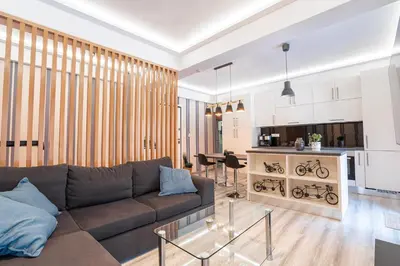 a living room with a couch and a table at Downtown Penthouse With Gym And Acropolis View in Athens