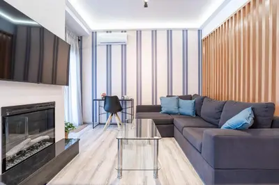a living room with a couch and a fireplace at Downtown Penthouse With Gym And Acropolis View in Athens