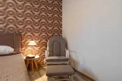 a bedroom with a bed and a chair and a table at Downtown Penthouse With Gym And Acropolis View in Athens