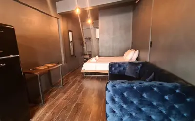a living room with a couch and a bed at The Black key in Athens