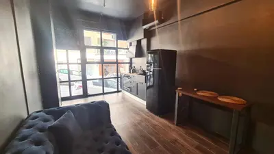 a kitchen with a couch and a table in a room at The Black key in Athens