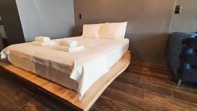 a bedroom with a bed with two towels on it at The Black key in Athens